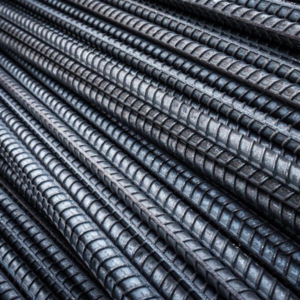Close-up of ribbed alloy rebar showing deformation patterns and metallic sheen