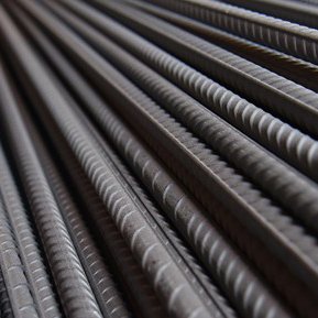 Close-up of ribbed alloy rebar showing deformation patterns and metallic sheen