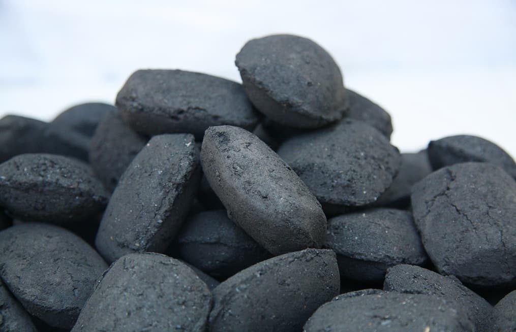 Close up image of a pile of iron Briquettes
