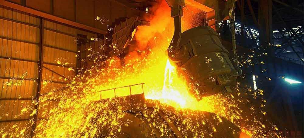 image of molten metal being poured out of a industrial ladle crucible