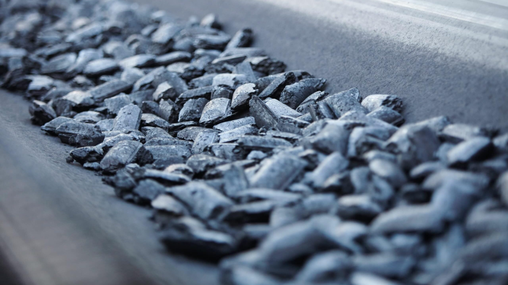 hot briquetted iron on a factory conveyor belt