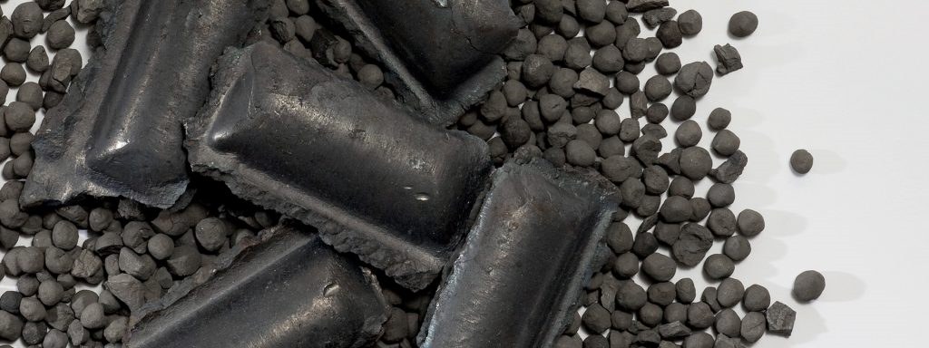 close up of a bunch of black hot briquetted iron