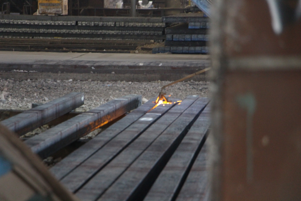 iron ingots being cut in factory