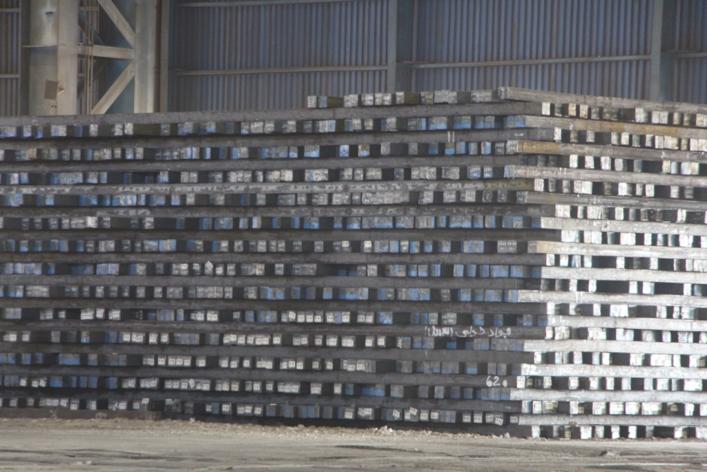 stacks of iron ingots in a factory yard