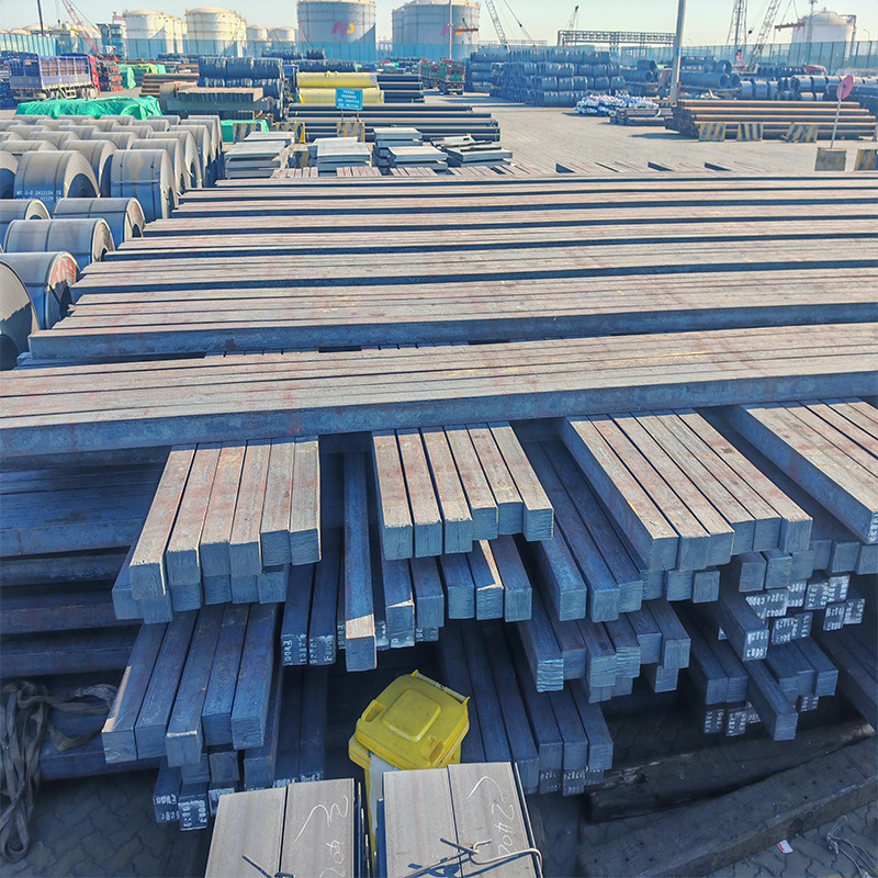 many stacks of steel billets in a port