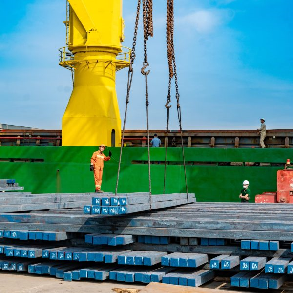 steel billets next to a ship waiting to be loaded