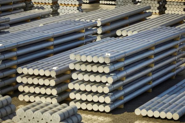 round billets stacked in a factory yard