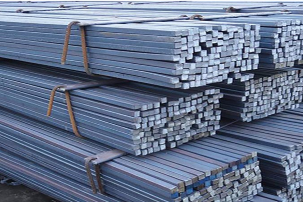 round billets stacked in a factory yard