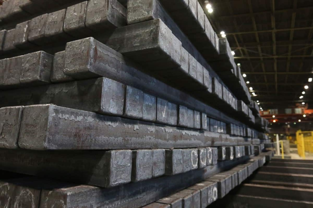 iron billets stacked in a factory warehouse