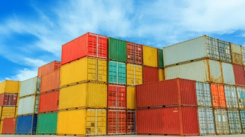ship containers stacked on top of eachother at a port
