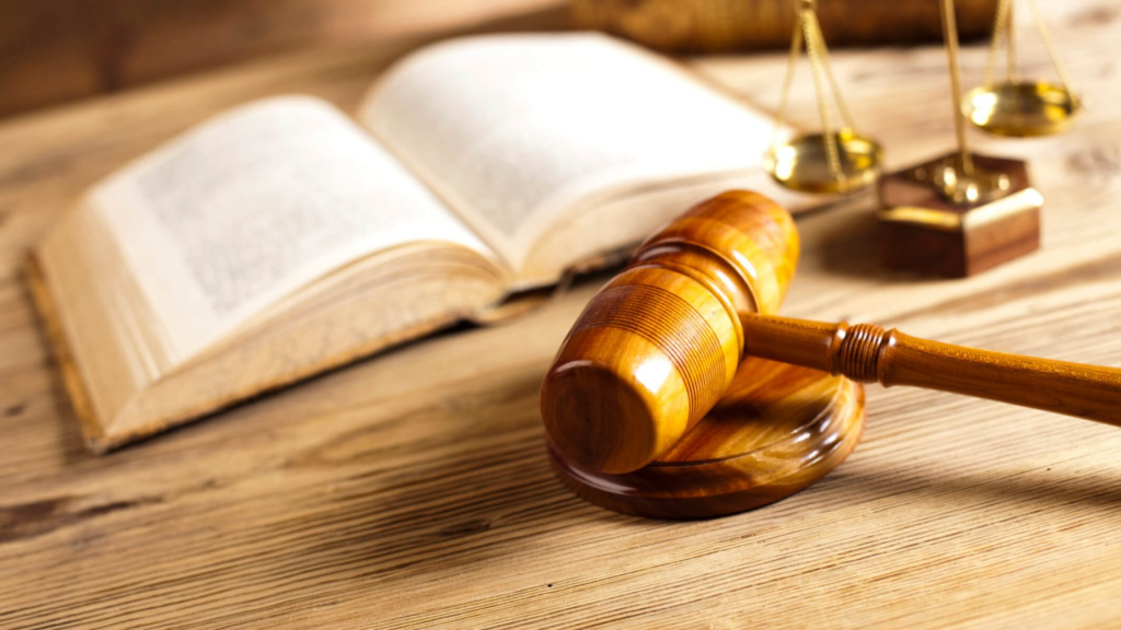 a judge gavel beside a book of law